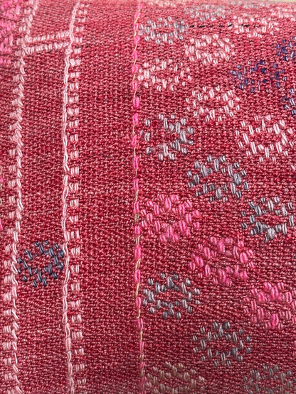 Rectangular red vintage Turkish kilim pillow with small repeating geometric patterns, made from handwoven wool.