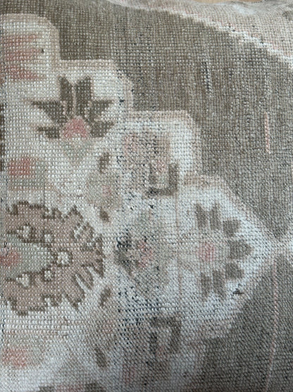 26x26 low-pile pillow made from upcycled Turkish rugs. Artisan-crafted in muted taupe, beige, and soft sage tones.