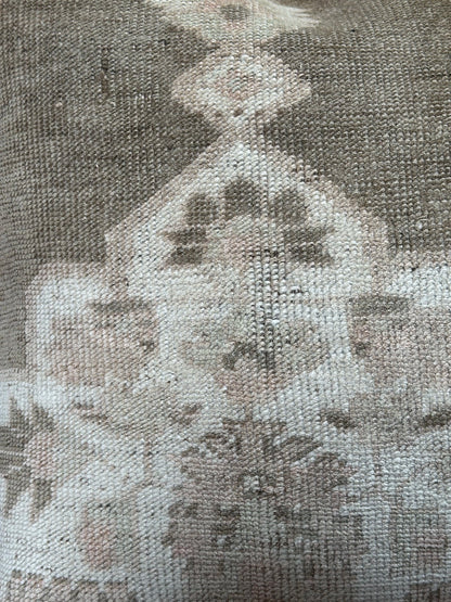 26x26 low-pile pillow made from upcycled Turkish rugs. Artisan-crafted in muted taupe, beige, and soft sage tones.