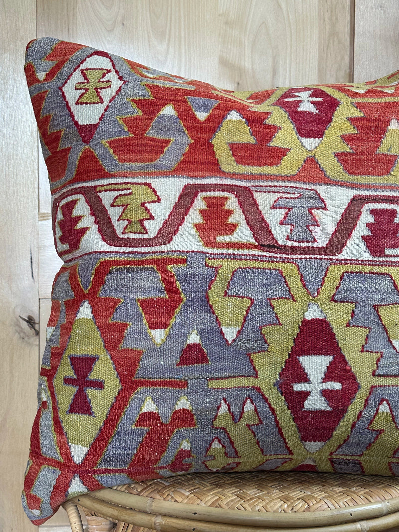 Large 26x26 kilim pillow sustainably handmade from vintage Turkish wool rugs. Features bold tribal motifs in olive, terracotta, and ivory tones.