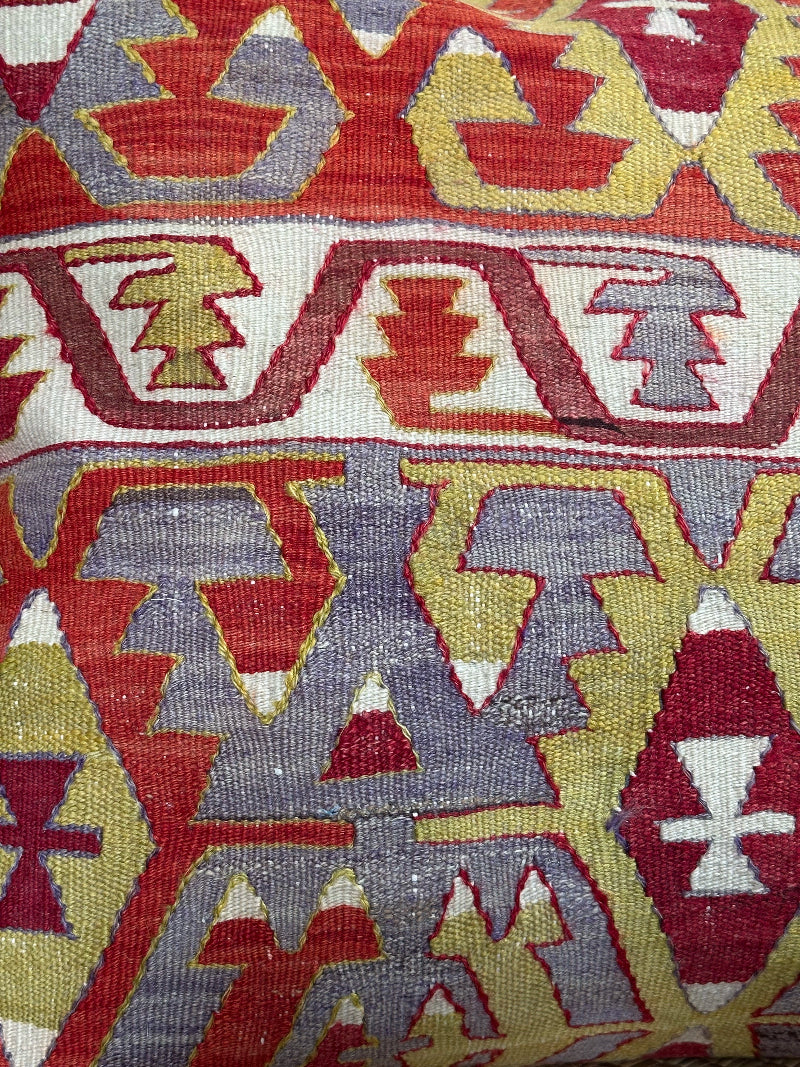 Large 26x26 kilim pillow sustainably handmade from vintage Turkish wool rugs. Features bold tribal motifs in olive, terracotta, and ivory tones.