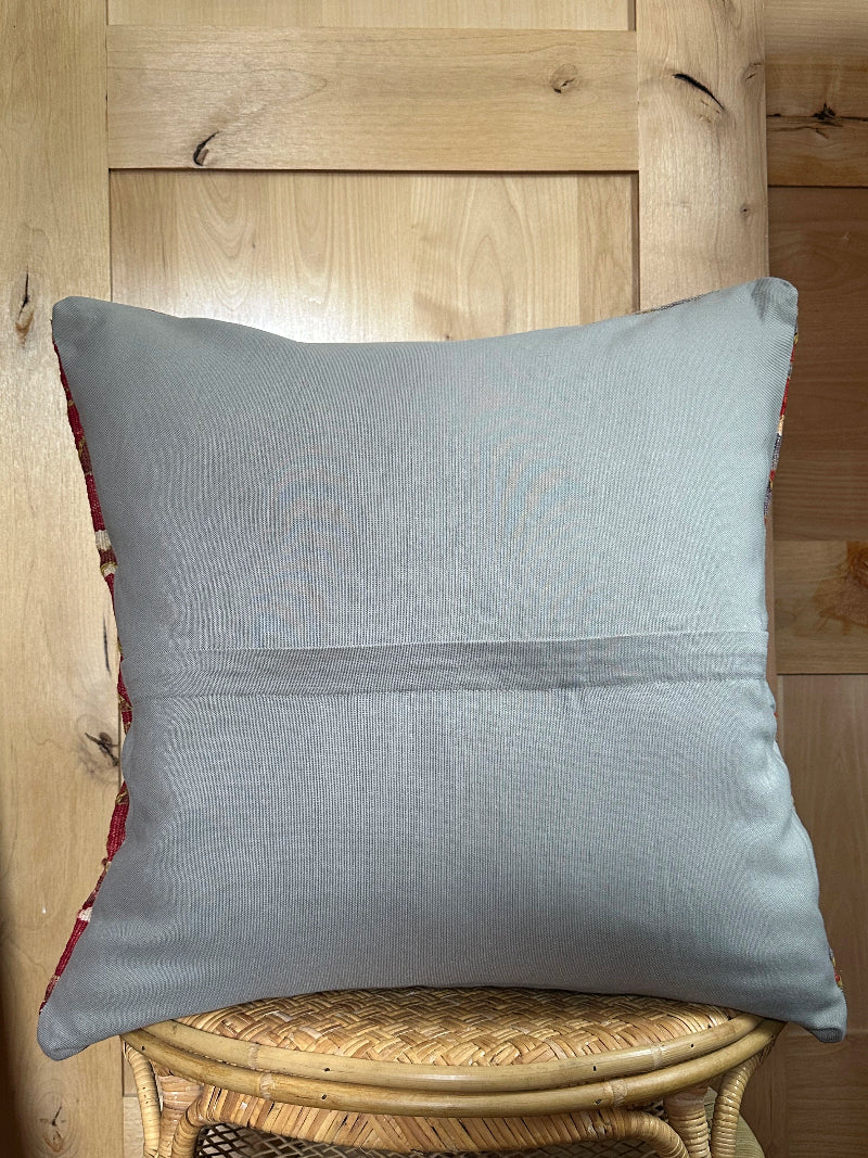 Large 26x26 kilim pillow sustainably handmade from vintage Turkish wool rugs. Features bold tribal motifs in olive, terracotta, and ivory tones.
