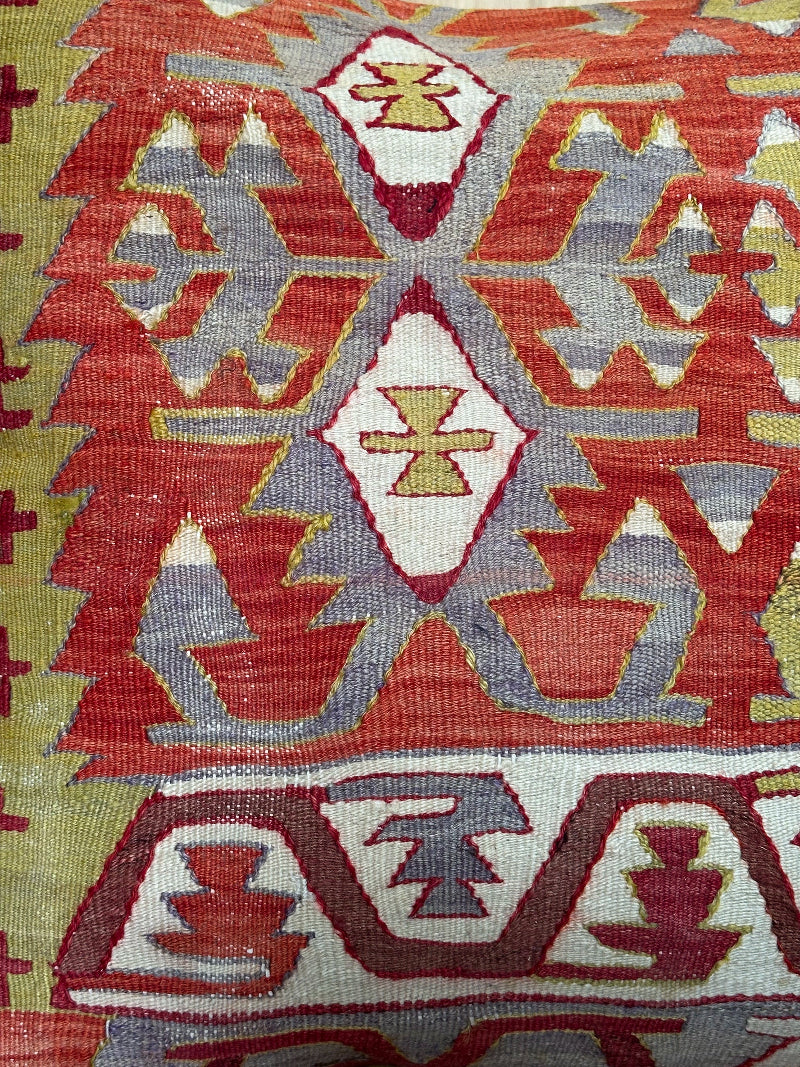 Large 26x26 kilim pillow sustainably handmade from vintage Turkish wool rugs. Features bold tribal motifs in olive, terracotta, and ivory tones.