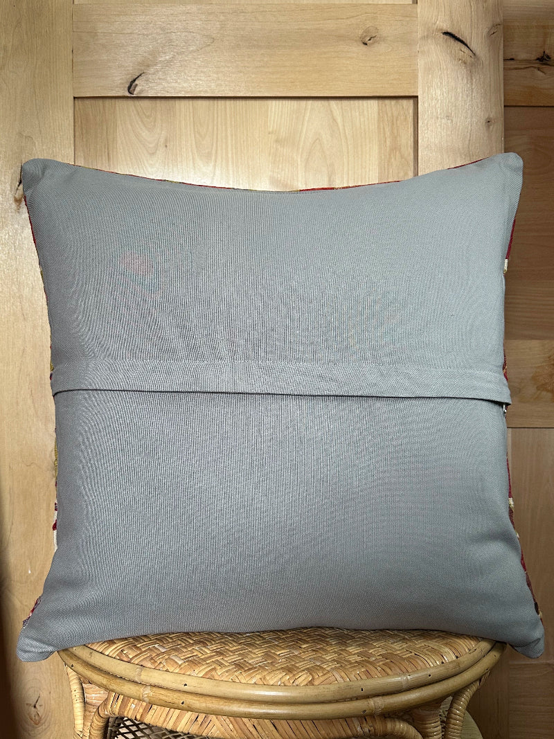 Large 26x26 kilim pillow sustainably handmade from vintage Turkish wool rugs. Features bold tribal motifs in olive, terracotta, and ivory tones.