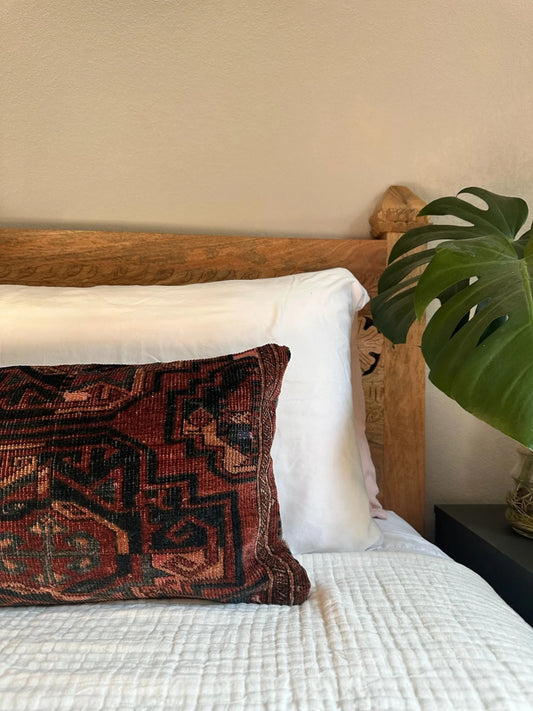 12 by 24 inch handmade Turkish lumbar pillows featuring a velvety soft pile and merlot red, pink and navy color palette.