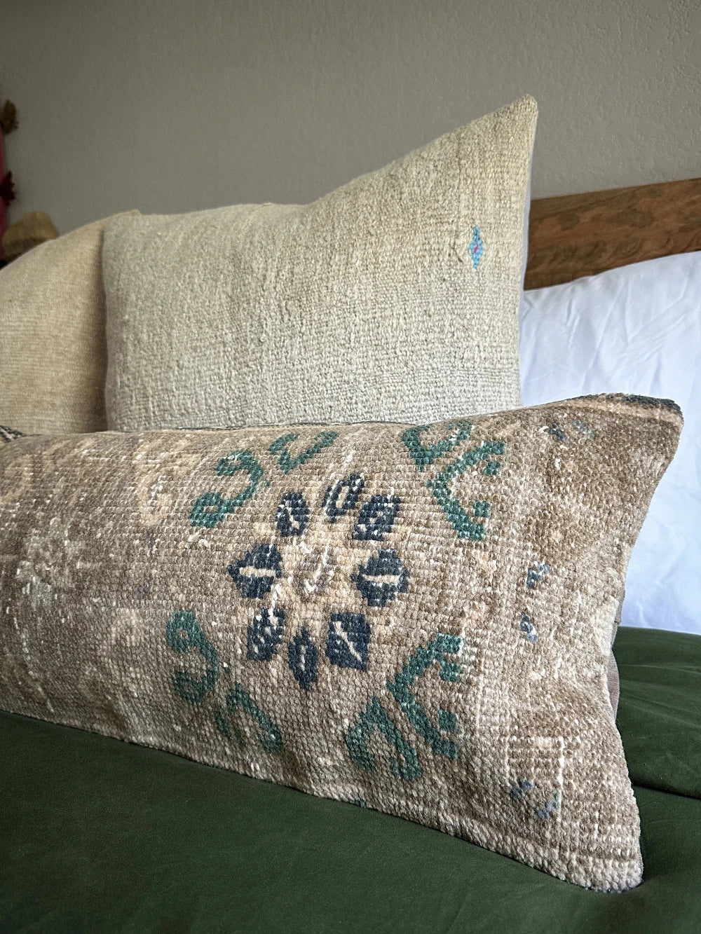 12 by 46 handmade Turkish lumbar pillow featuring a floral and diamond geometric pattern across the face of the pillow