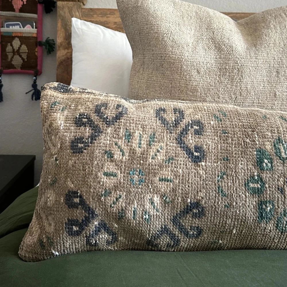 12 by 46 handmade Turkish lumbar pillow featuring a floral and diamond geometric pattern across the face of the pillow