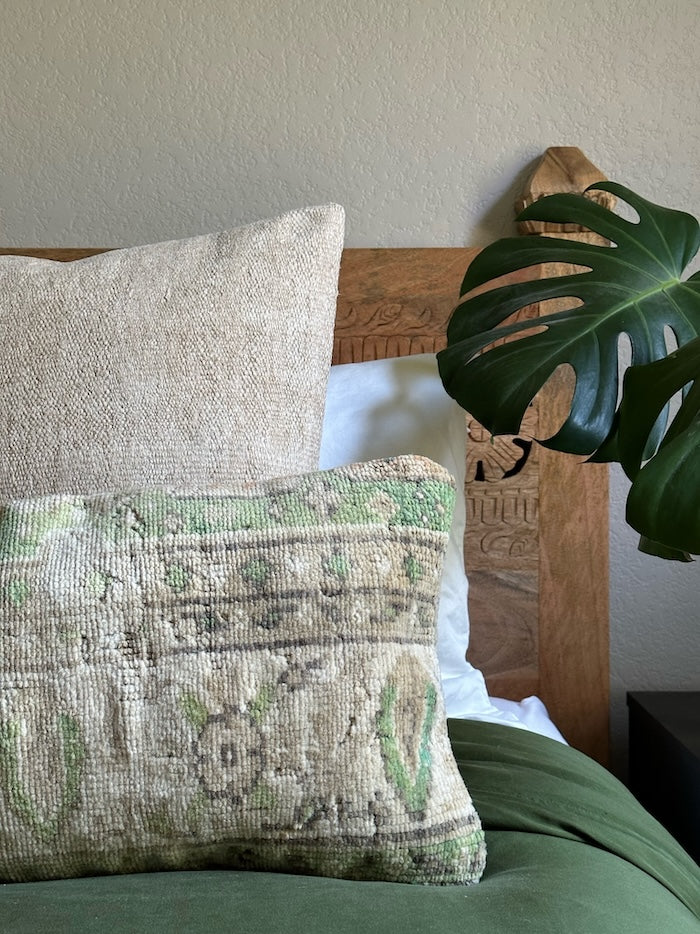 12x47 Turkish lumbar pillow featuring muted brown tones and pops of green near the top border