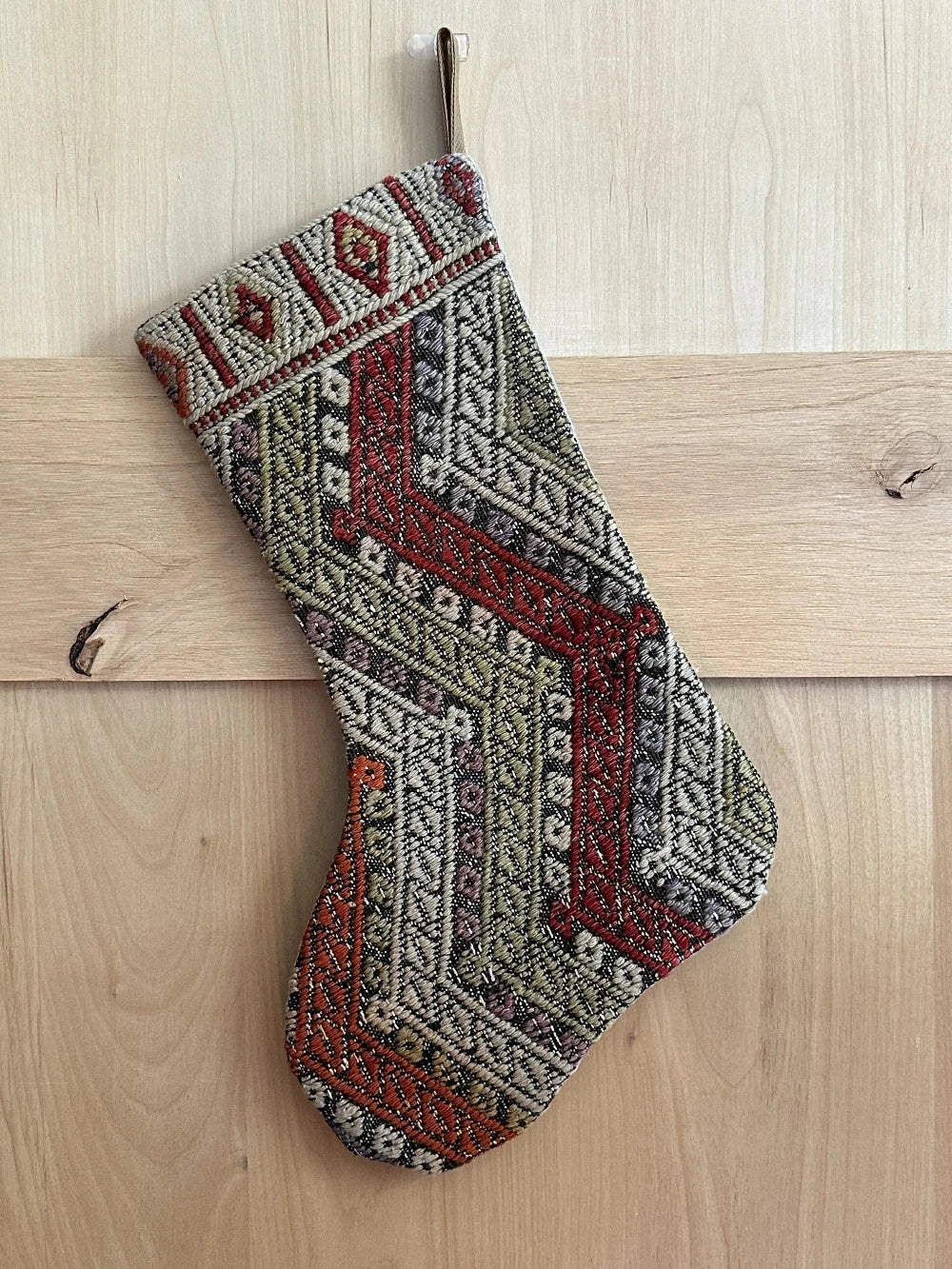 handmade and colorful Turkish Christmas stocking featuring red white and green striped geometric design