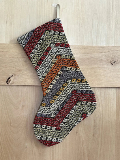 colorful striped turkish christmas stocking featuring red, green, orange and blue embroidered geometric lines