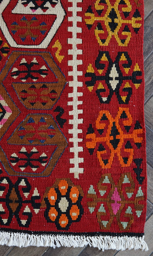 5 by 3 bright red Turkish area rug featuring floral and geometric border with pops of green, yellow, orange, perfect condition