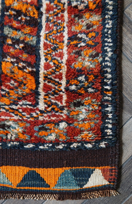 11 foot by 3 foot Turkish high pile Herki runner, featuring a black, red and orange geometric pattern throughout