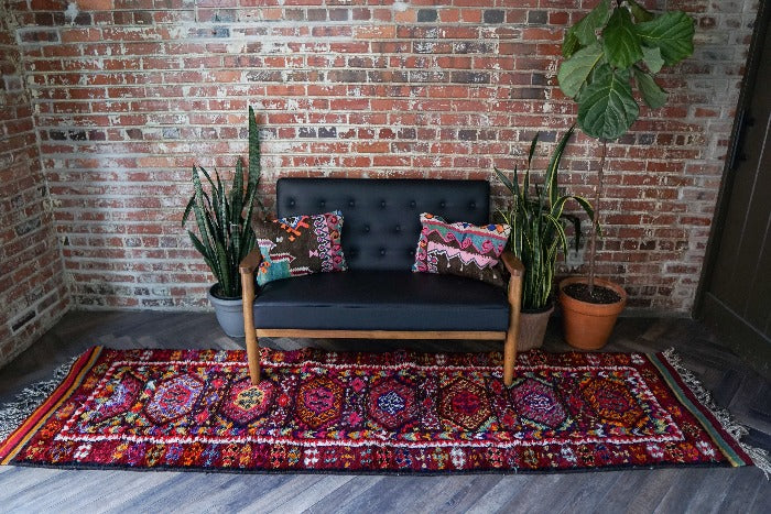 10.5 by 3 foot colorful Turkish runner featuring high pile and multicolored geometric patterns throughout