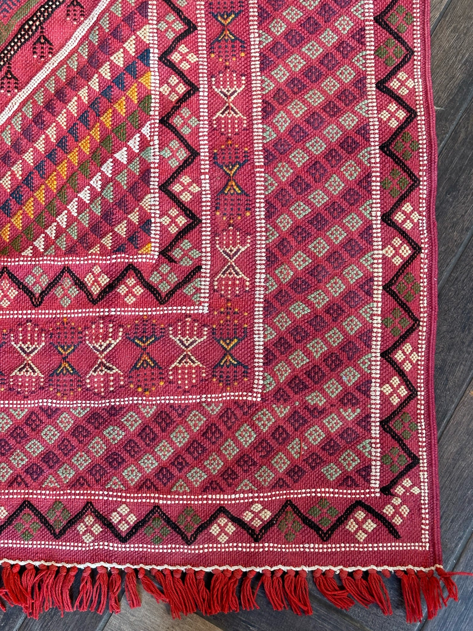 bright pink embroidered Turkish area rug with fringe