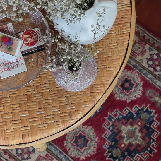 Hand-knotted 2x3 foot mini pile rug featuring a colorful geometric design, large central motif and geometric border - wool material with pops of red, light blue, navy and white. 