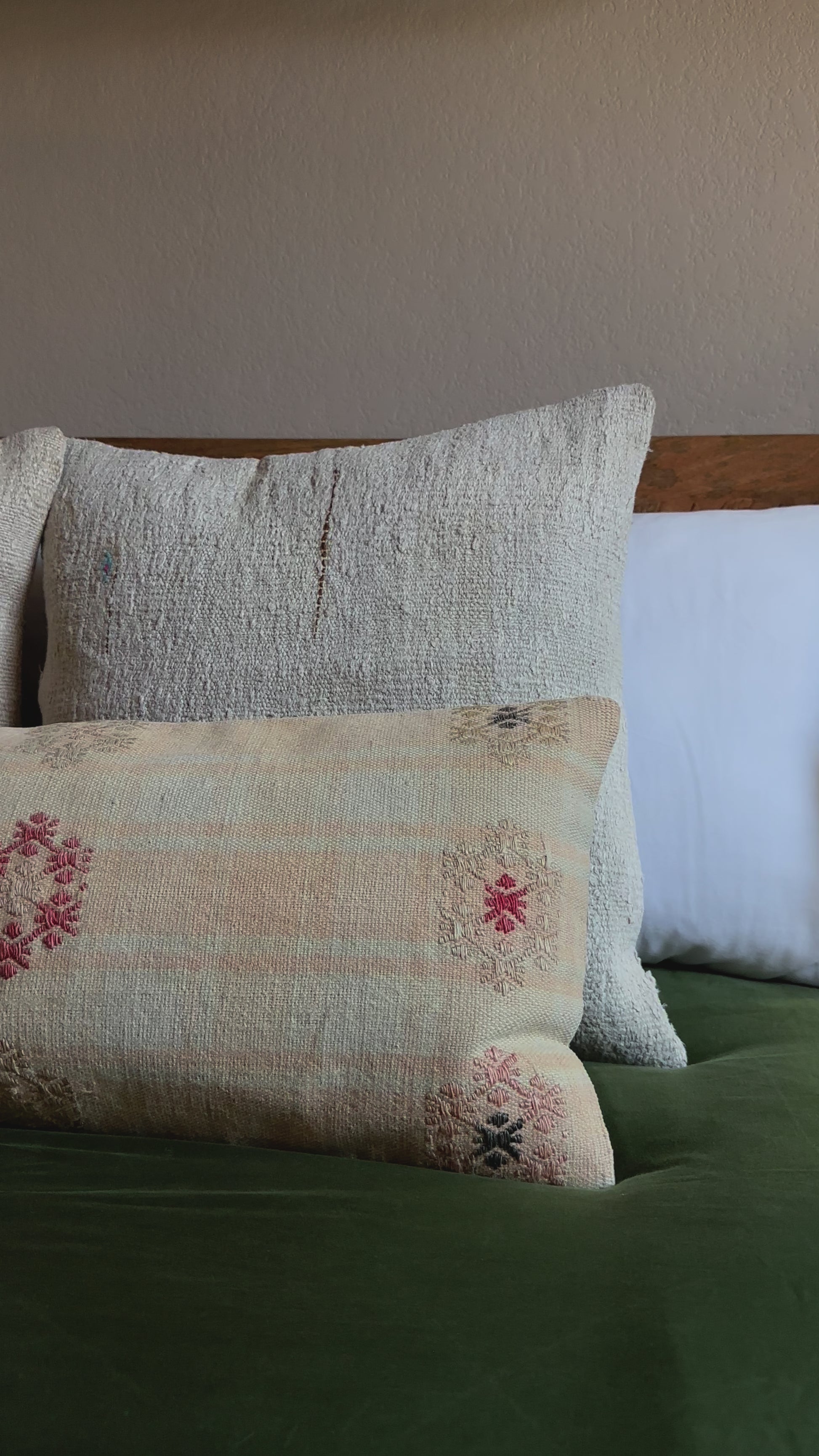 12 by 36 neutral lumbar pillow featuring light yellow and blue plaid and colorful floral embroidery throughout