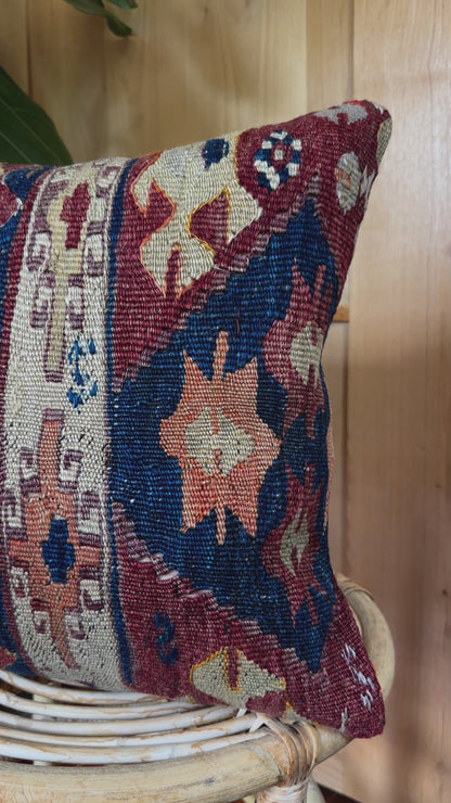 Handwoven red and green Turkish throw pillow, 16x16 inches, wool front with geometric design and pops of light blue and maroon, cotton backing—boho home decor.