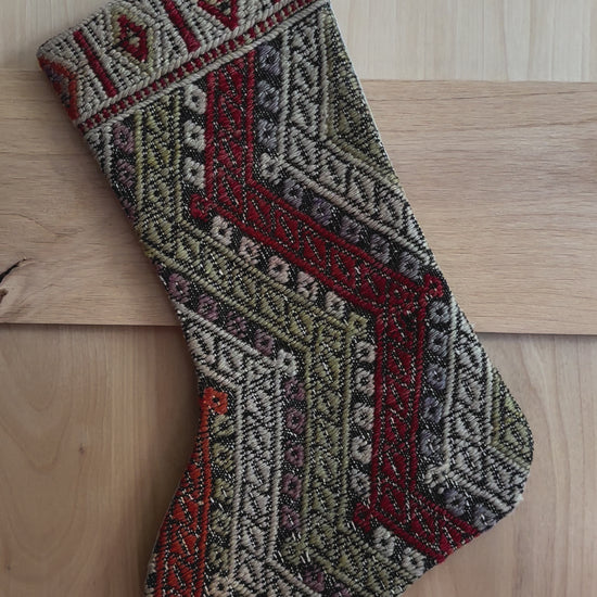 handmade and colorful Turkish Christmas stocking featuring red white and green striped geometric design