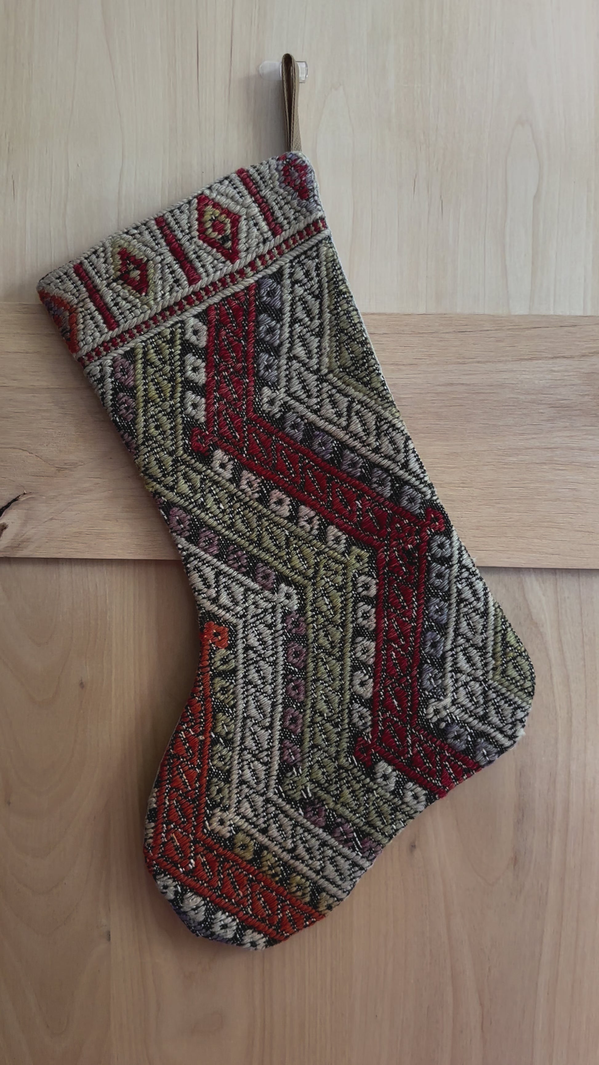 handmade and colorful Turkish Christmas stocking featuring red white and green striped geometric design