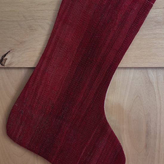 Solid red handmade turkish Christmas stocking featuring a deep fire engine red hue