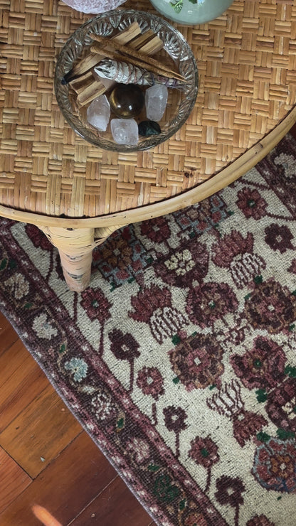 Vintage Turkish wool rug with a floral tree of life design in burgundy, green, and ivory tones, featuring a detailed border of small floral motifs.
