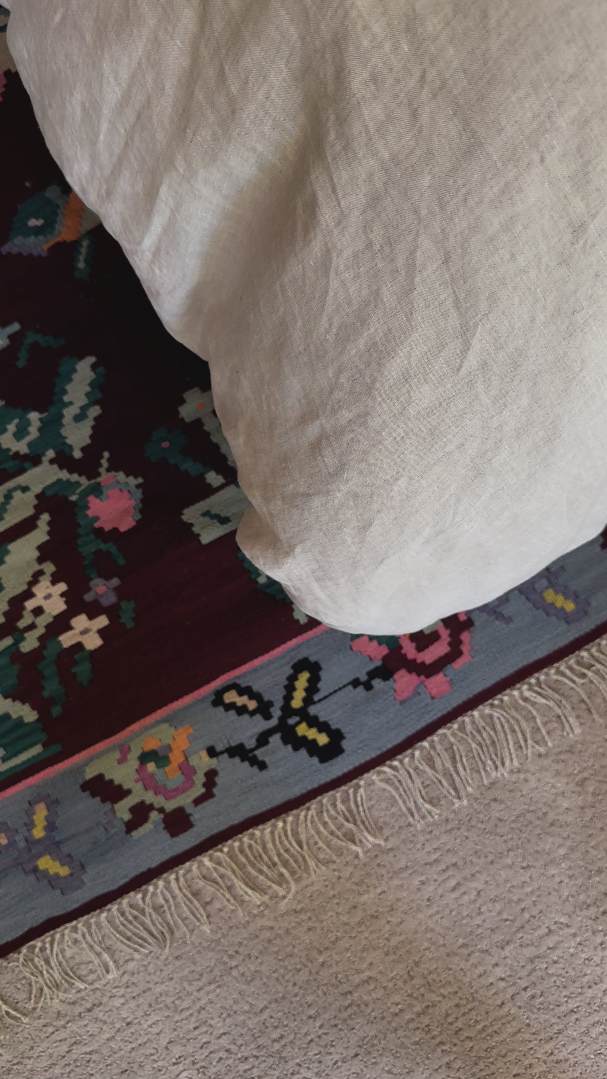 Large handmade rug featuring a sky blue floral border and a coffee brown inner field with large floral design