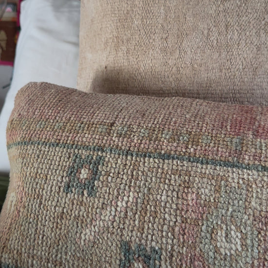 12 by 36 neutral lumbar pillow featuring a floral geometric design with pops of dusty rose and navy blue