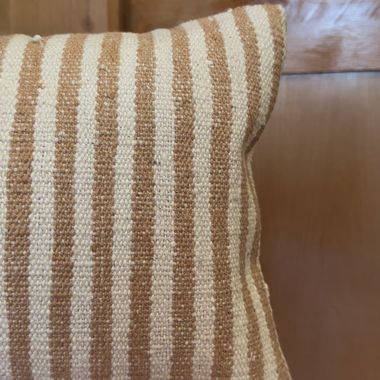 12 by 24 cream and brown lumbar pillow featuring an all over vertical striped pattern