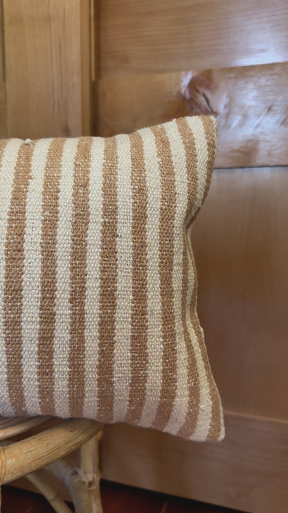 12 by 24 cream and brown lumbar pillow featuring an all over vertical striped pattern