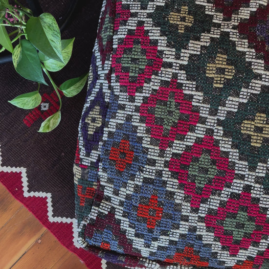 Handmade vintage Turkish rug pouf with colorful tones, up-cycled from authentic wool Kilim rugs. Perfect as a unique bohemian floor cushion, ottoman, or accent seating for living rooms, bedrooms, or cozy spaces. Ethically crafted by artisans in Turkey.