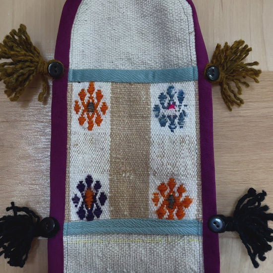 3 pocket hanging wall organizer made from Turkish rug fragments featuring embroidered floral pockets