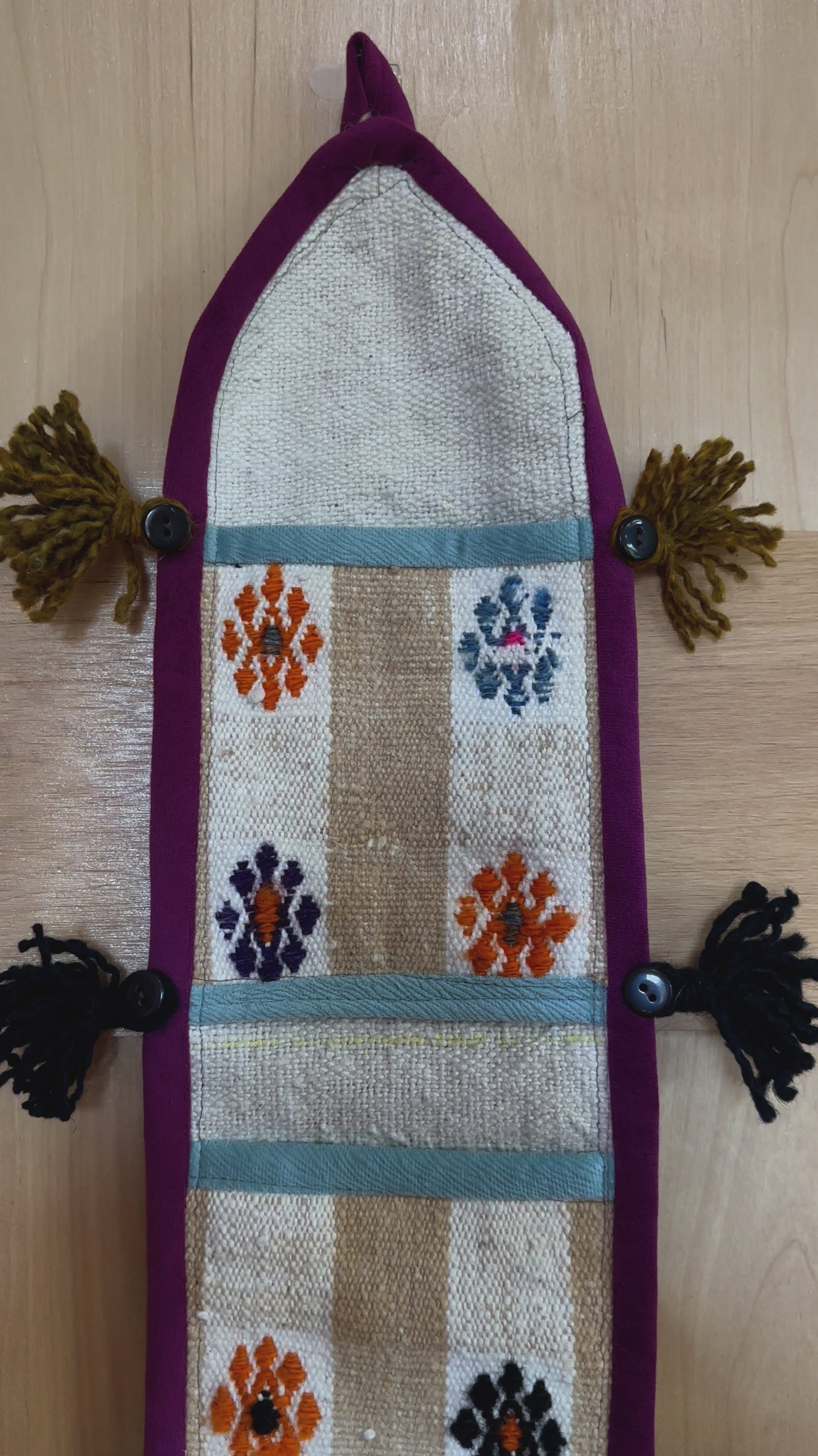 3 pocket hanging wall organizer made from Turkish rug fragments featuring embroidered floral pockets