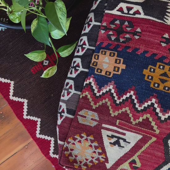 Handmade vintage Turkish rug pouf with geometric colorful tones, up-cycled from authentic wool Kilim rugs. Perfect as a unique bohemian floor cushion, ottoman, or accent seating for living rooms, bedrooms, or cozy spaces. Ethically crafted by artisans in Turkey.