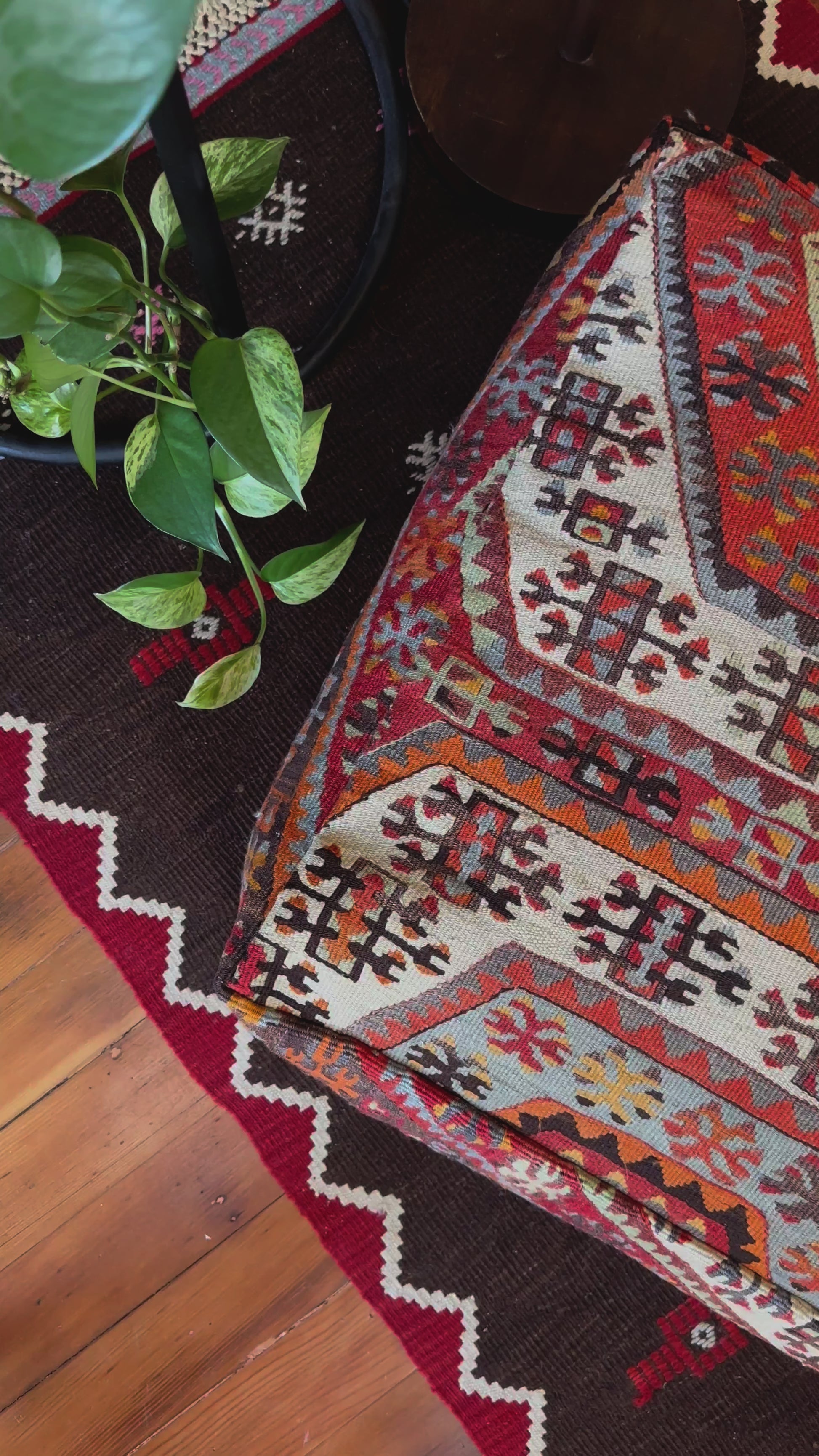 Handmade vintage Turkish rug pouf with red and orange tones, up-cycled from authentic wool Kilim rugs. Perfect as a unique bohemian floor cushion, ottoman, or accent seating for living rooms, bedrooms, or cozy spaces. Ethically crafted by artisans in Turkey.