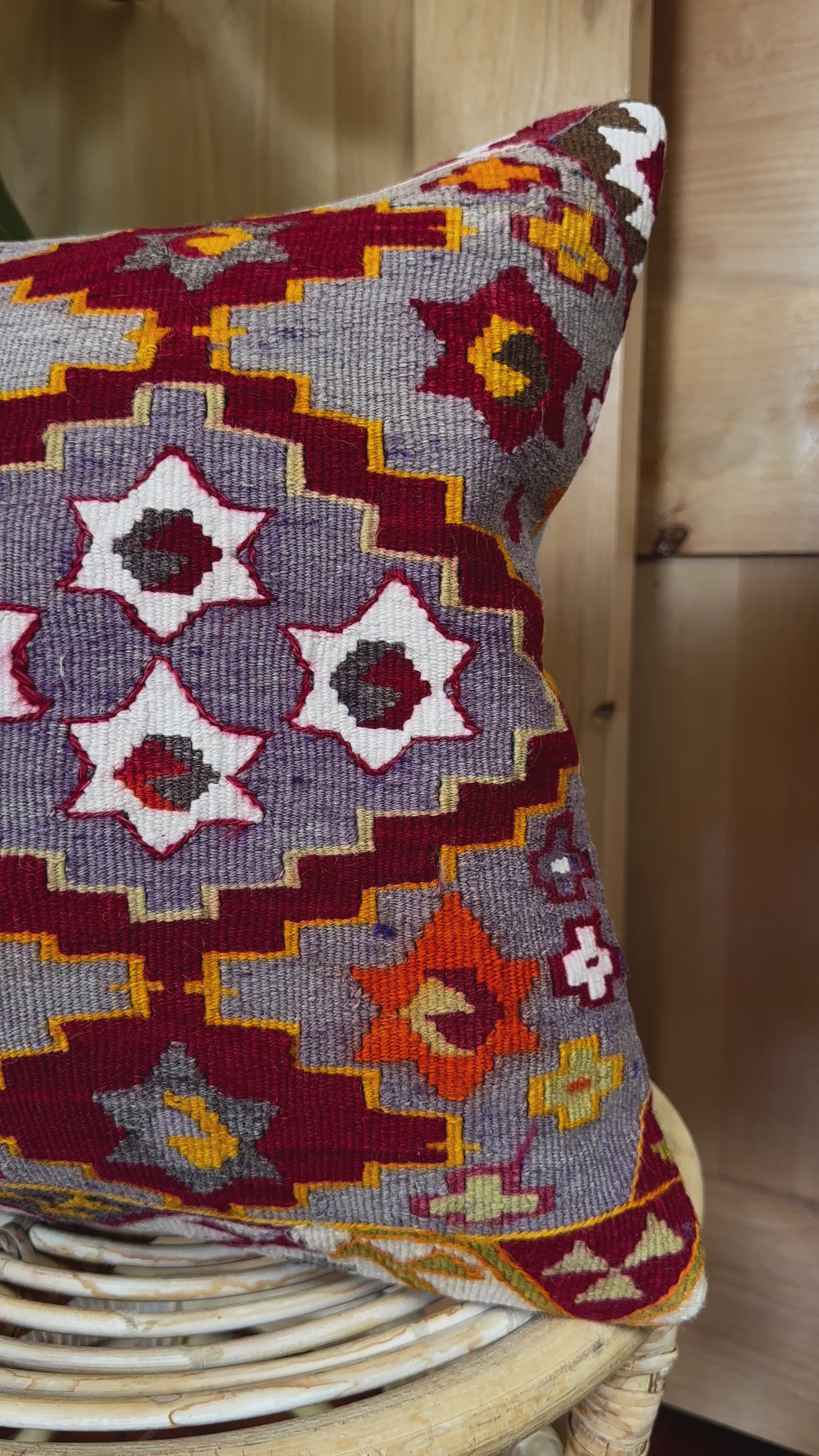 Handwoven purple Turkish throw pillow, 16x16 inches, wool front with geometric star design and pops of orange and red, cotton backing—boho home decor.